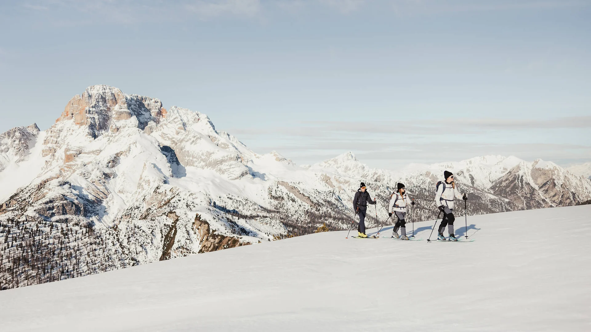 Cross-country skiing & ski touring hotel © Alex Moling Three ski tourers hiking on snow with snowy mountains in background