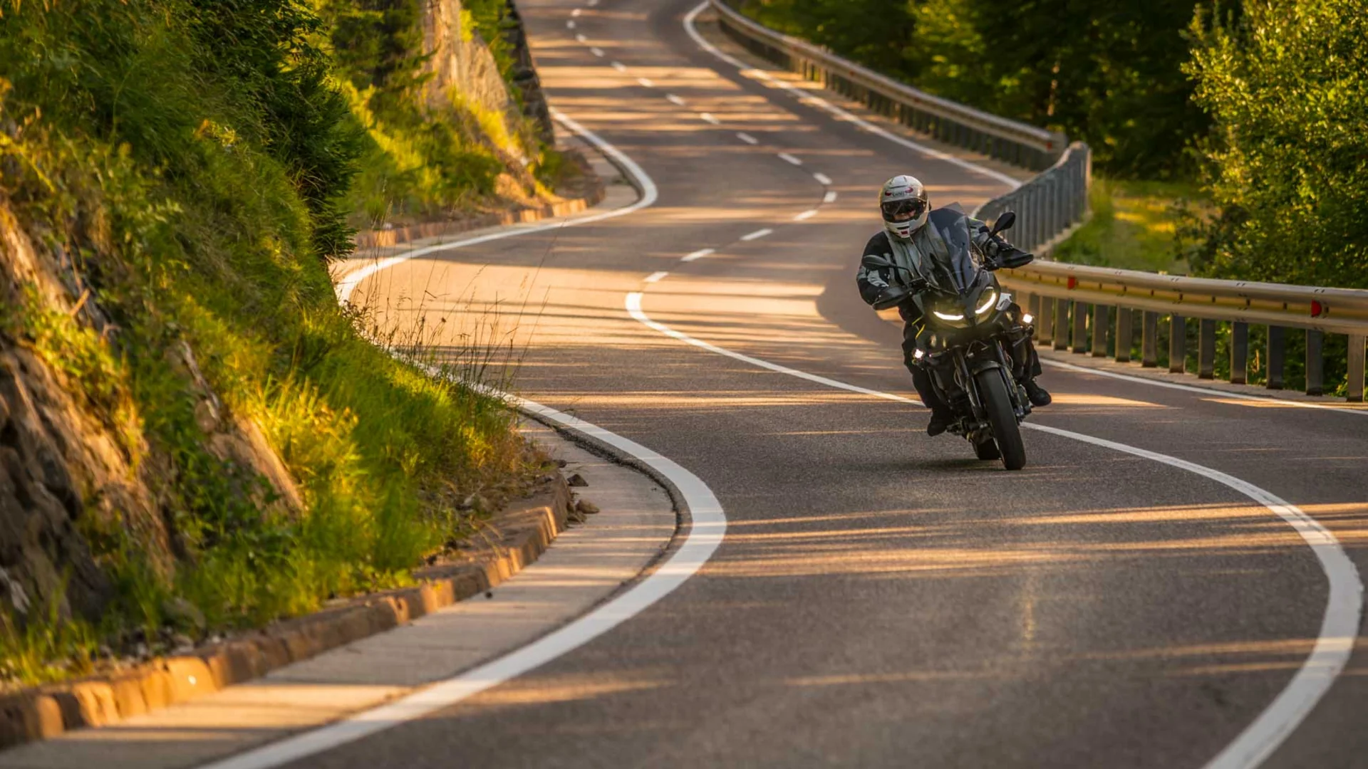 MTS Austria © Moppetfoto.de Motorcyclist riding on winding country road in sunny landscape