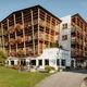 Hotel Melodia del Bosco with wooden balconies and flowers in a green setting