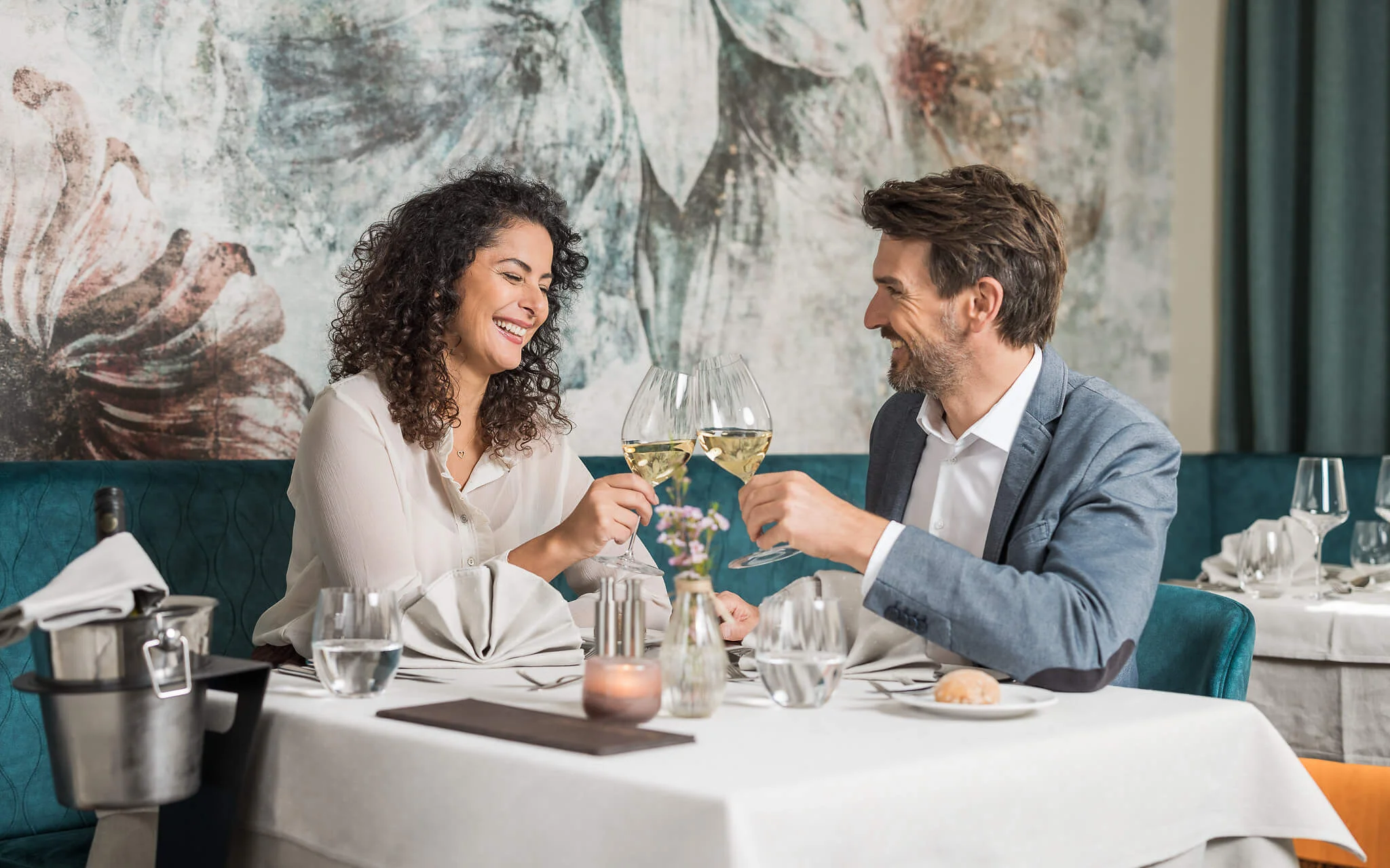 Cross Country Ski Holidays © David Johansson Couple toasting with white wine glasses at a restaurant