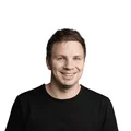 Portrait of a smiling man wearing a black t-shirt on a white background