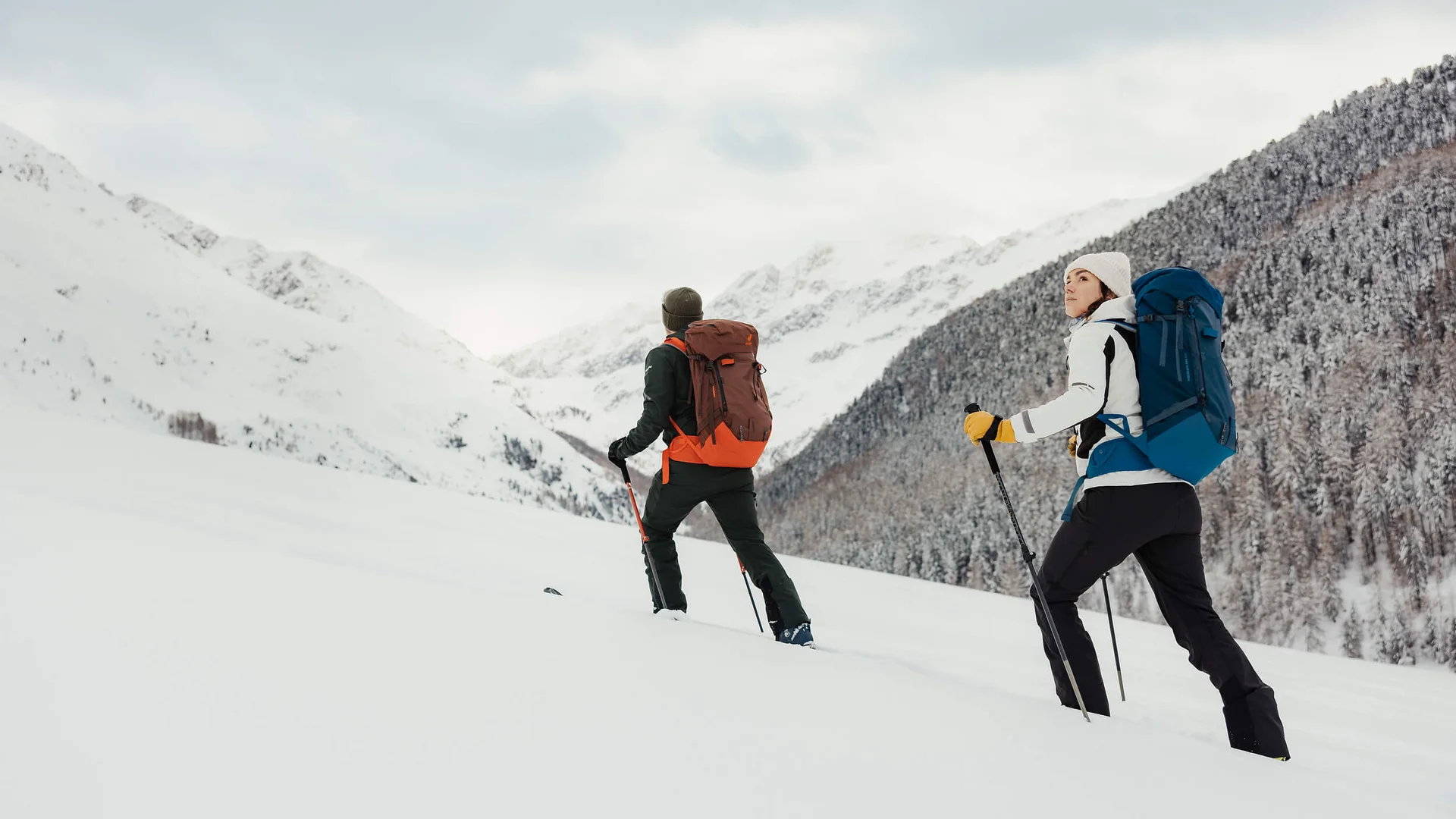 Cross-country skiing & ski touring hotel © Alex Moling Two hikers with backpacks trekking through snowy mountain terrain