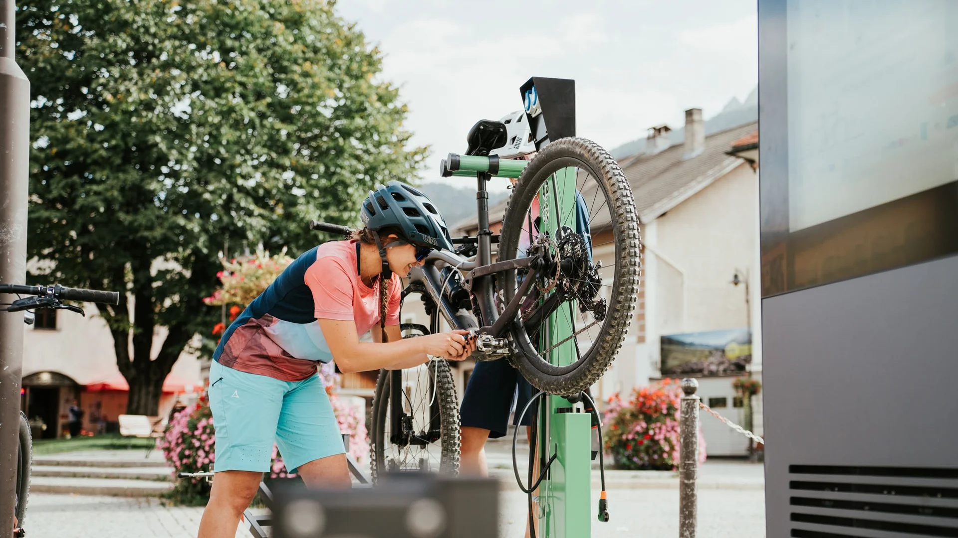 Careers © Desire Lines Woman fixing bike at outdoor public bike repair station